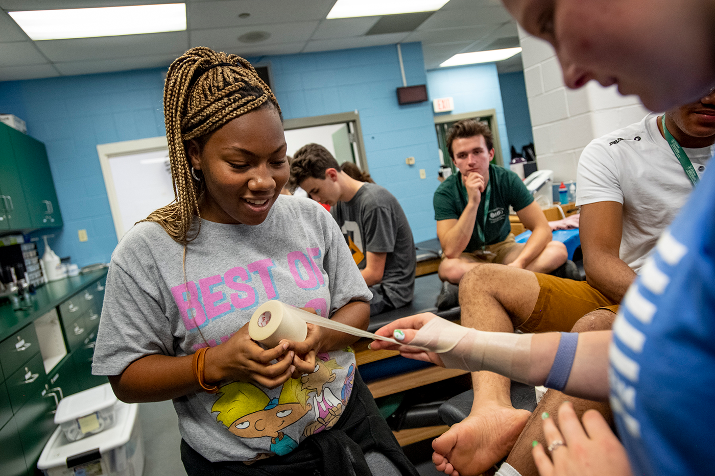A student practices wrapping an injury in the Sports Medicine class.
