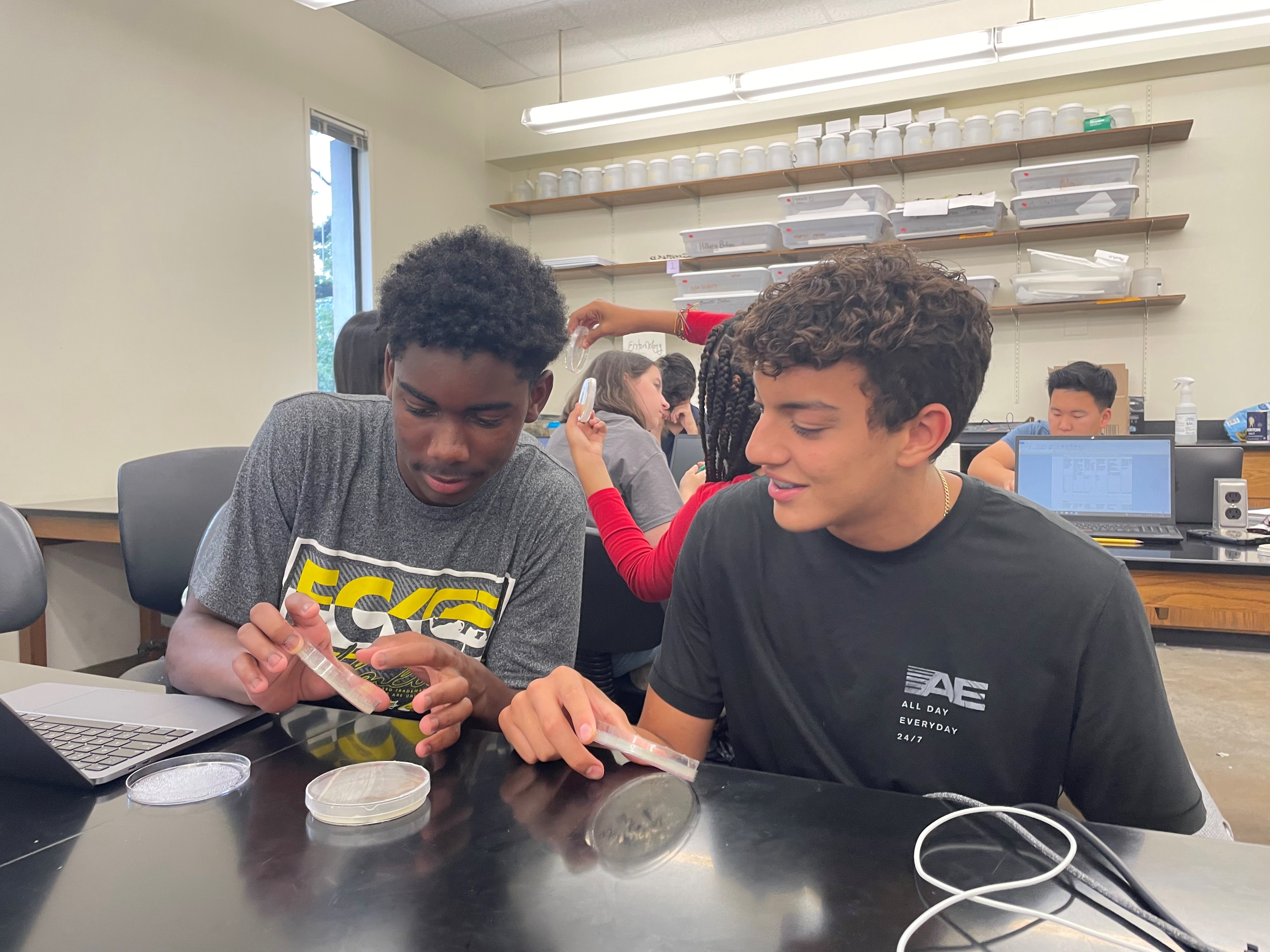 Pre-college students examining samples collected from a visit to Bayou Sauvage