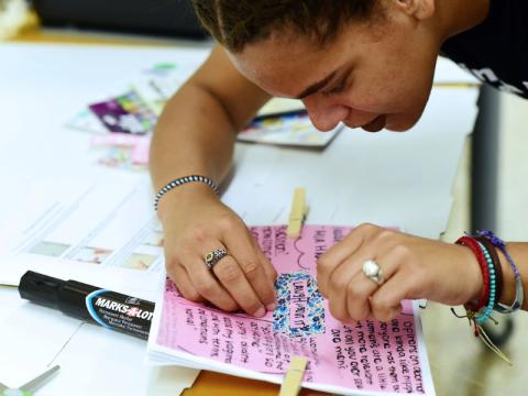 student working on zine