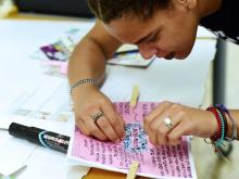 student working on zine