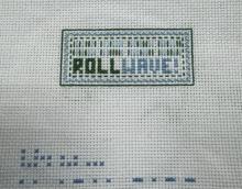 Embroidery with "ROLLWAVE!" and decorative border created by a pre-college student.